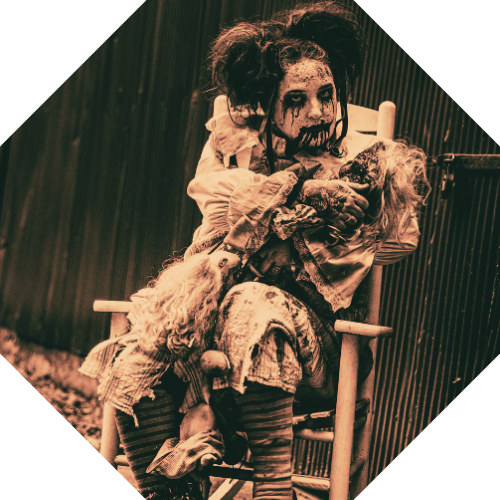 Octagonal sepia portrait of Jolly, a doll-like figure in a torn dress and pigtails, seated in a rocking chair holding a doll.