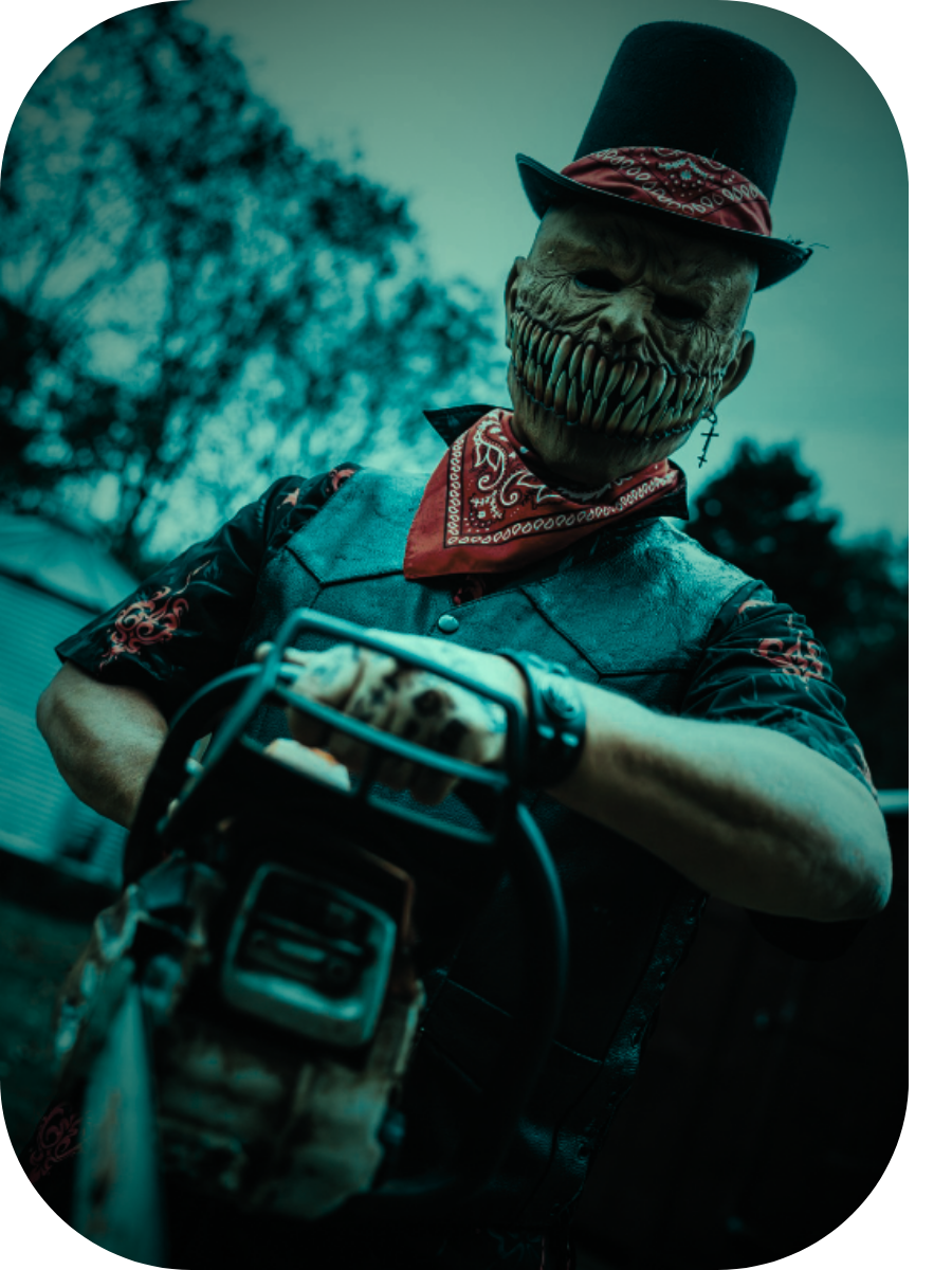 Slasher: a top-hatted figure in a stitched mask and red bandana gripping a chainsaw.